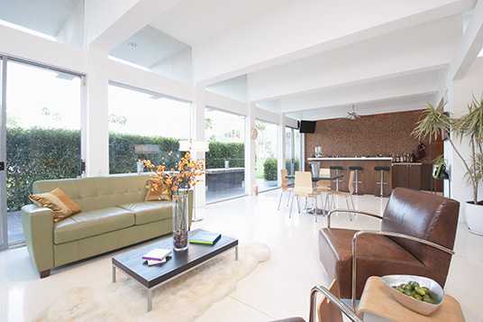 Contrasting coloured leather furniture in open plan living area